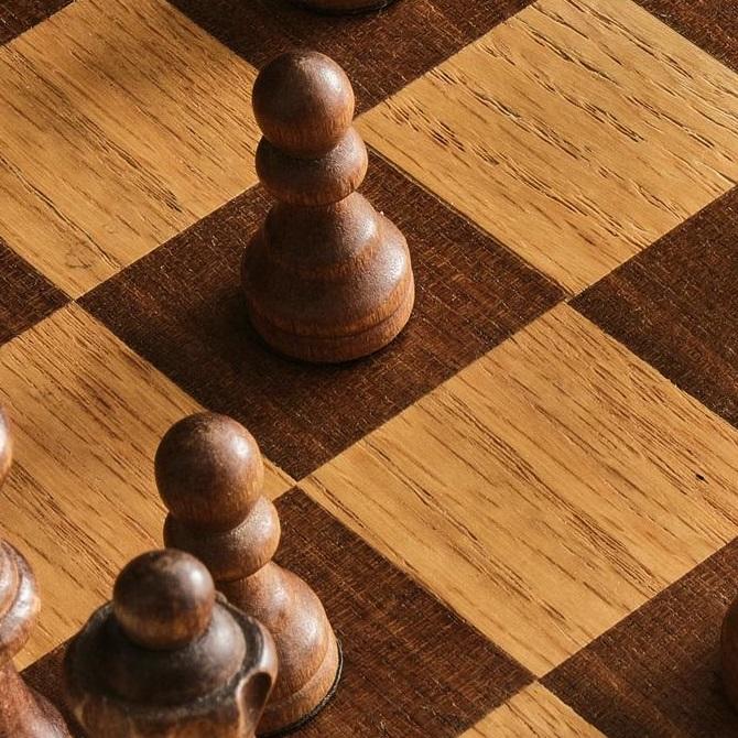 A close-up of a wooden chessboard.